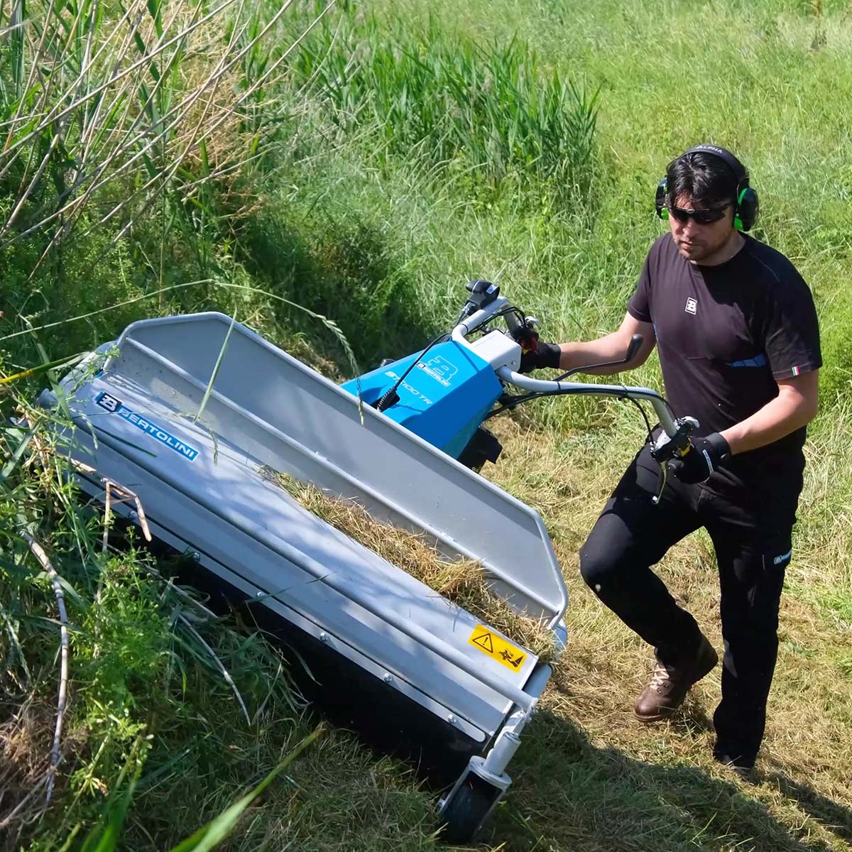 Bertolini BTS 100 flail mower clearing thick tall grass on a slope in a pasture on a farm
