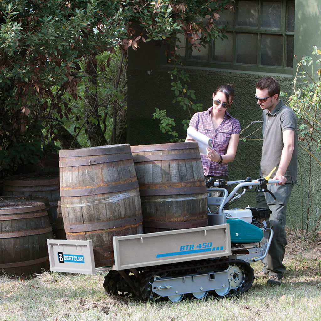 Bertolini BTR 450 transporter with an extendable deck and tracks for navigating slopes and rough terrain moving heavy barrels at a vineyard
